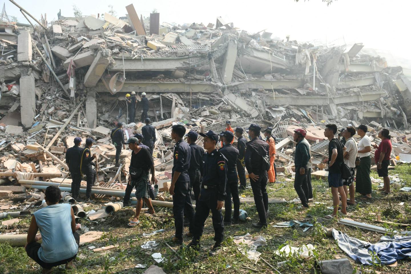 Rescuers search for survivors trapped in the collapsed Sky Villa Condominium building in Mandalay on Saturday.