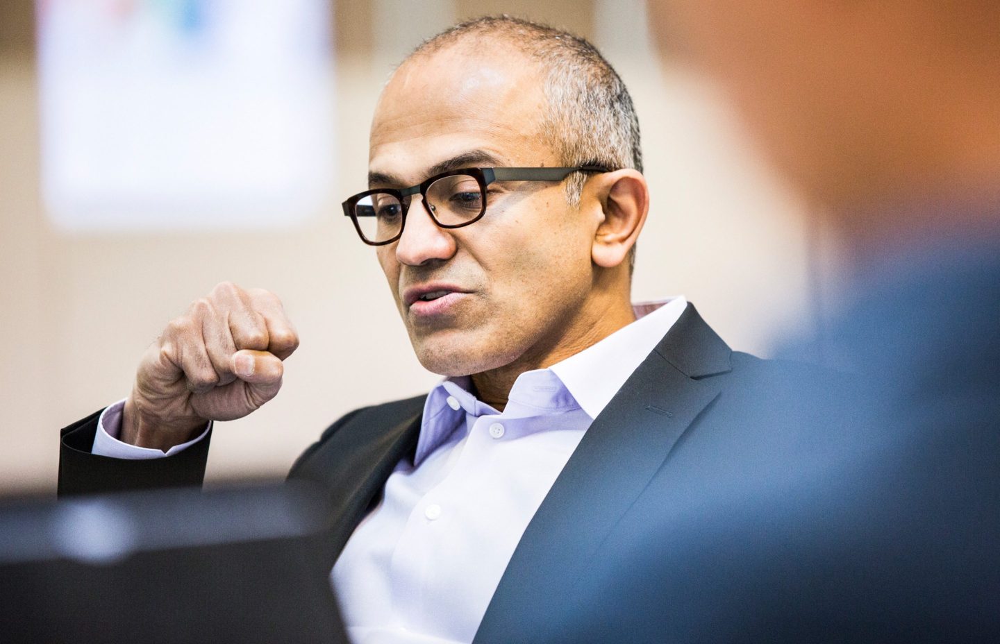 Microsoft CEO Satya Nadella with his hand raised
