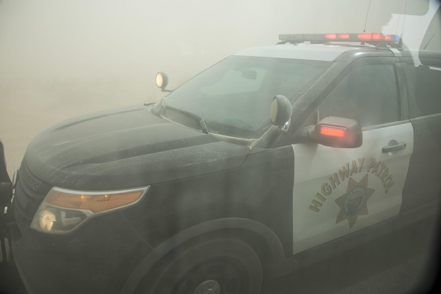 A Highway Patrol officer assists motorists