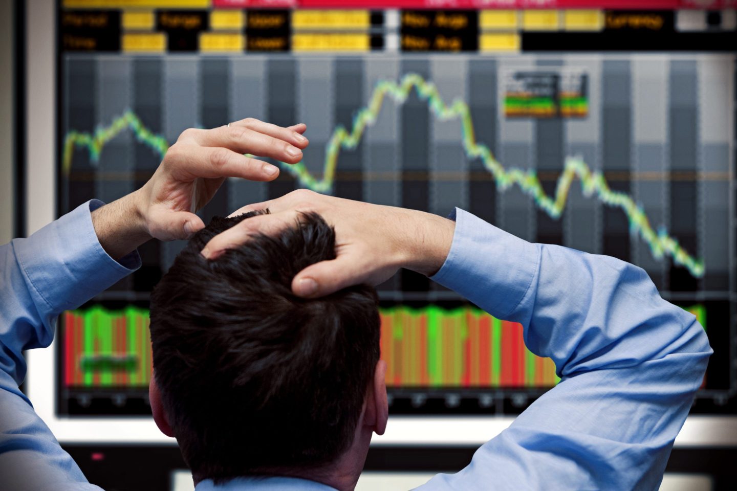 stressed man looking at stocks
