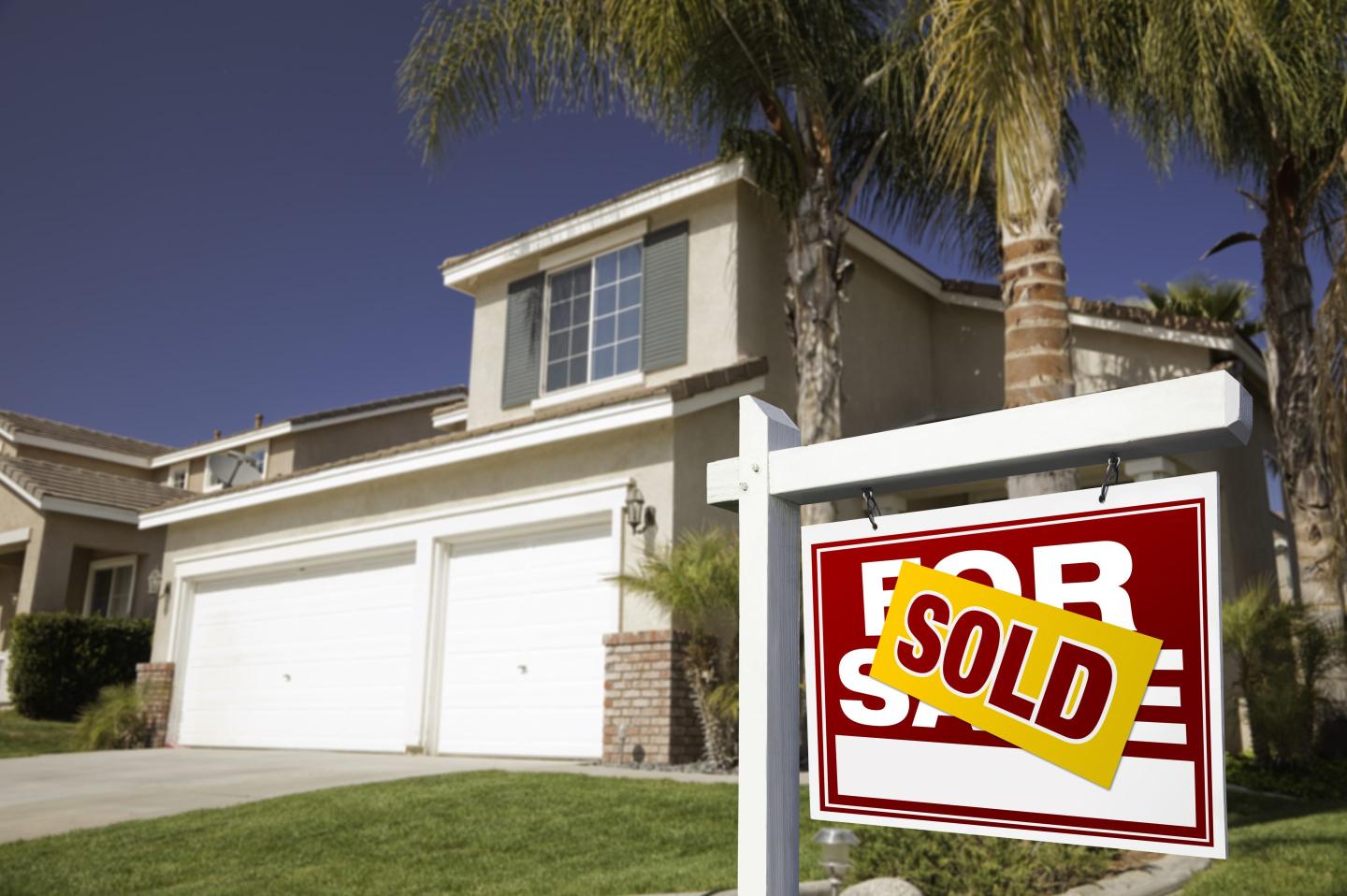 A home with a sold sign out front.