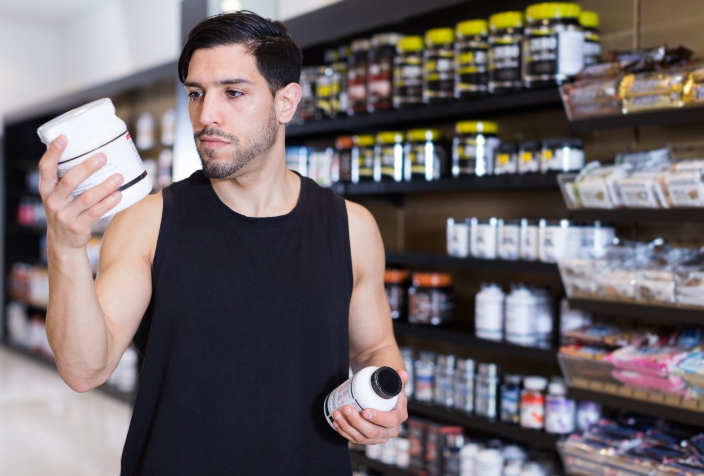 Man in a store looking at nutritional supplements