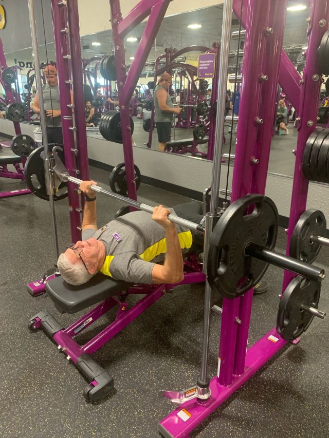older man exercising at the gym