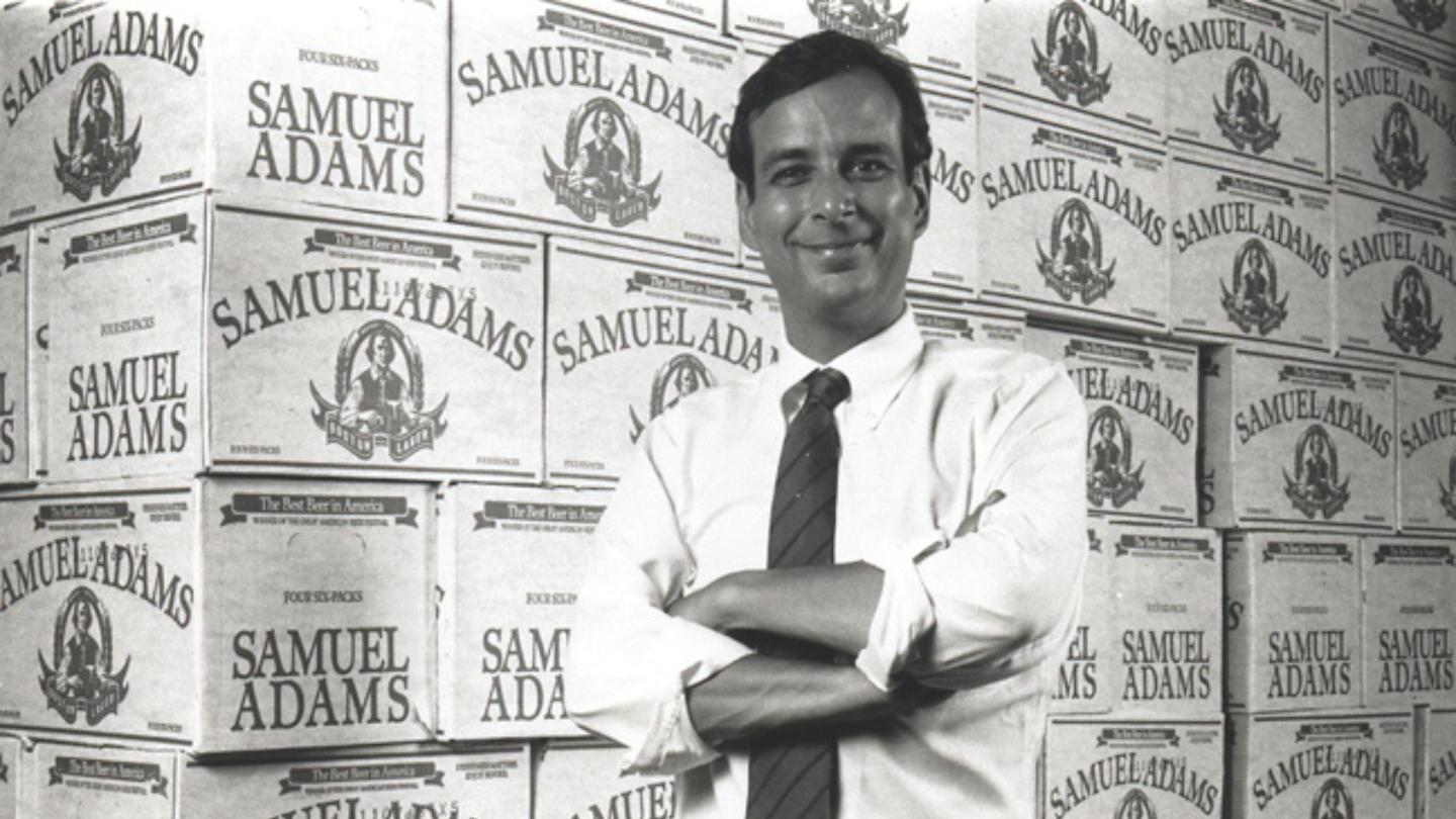 Founder Jim Koch poses by cases of Samuel Adams.
