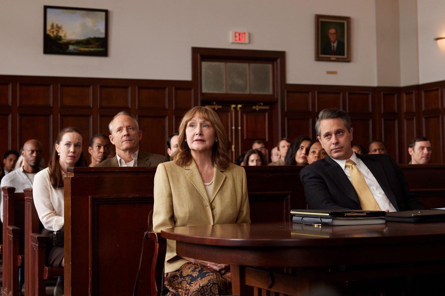Patricia Clarkson in period costume sitting in a court room