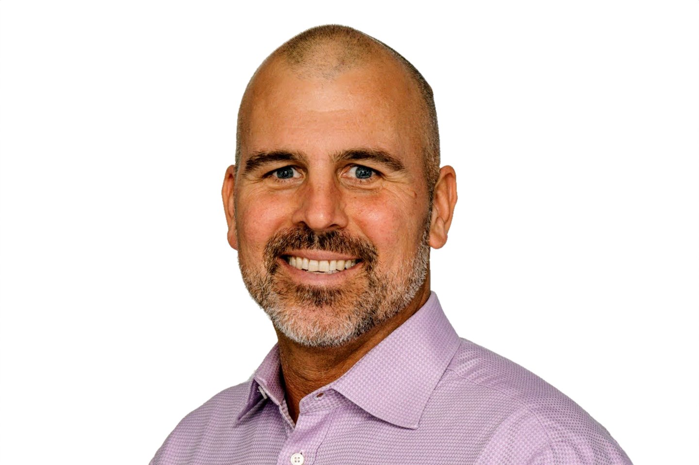 A man in a button down shirt smiles