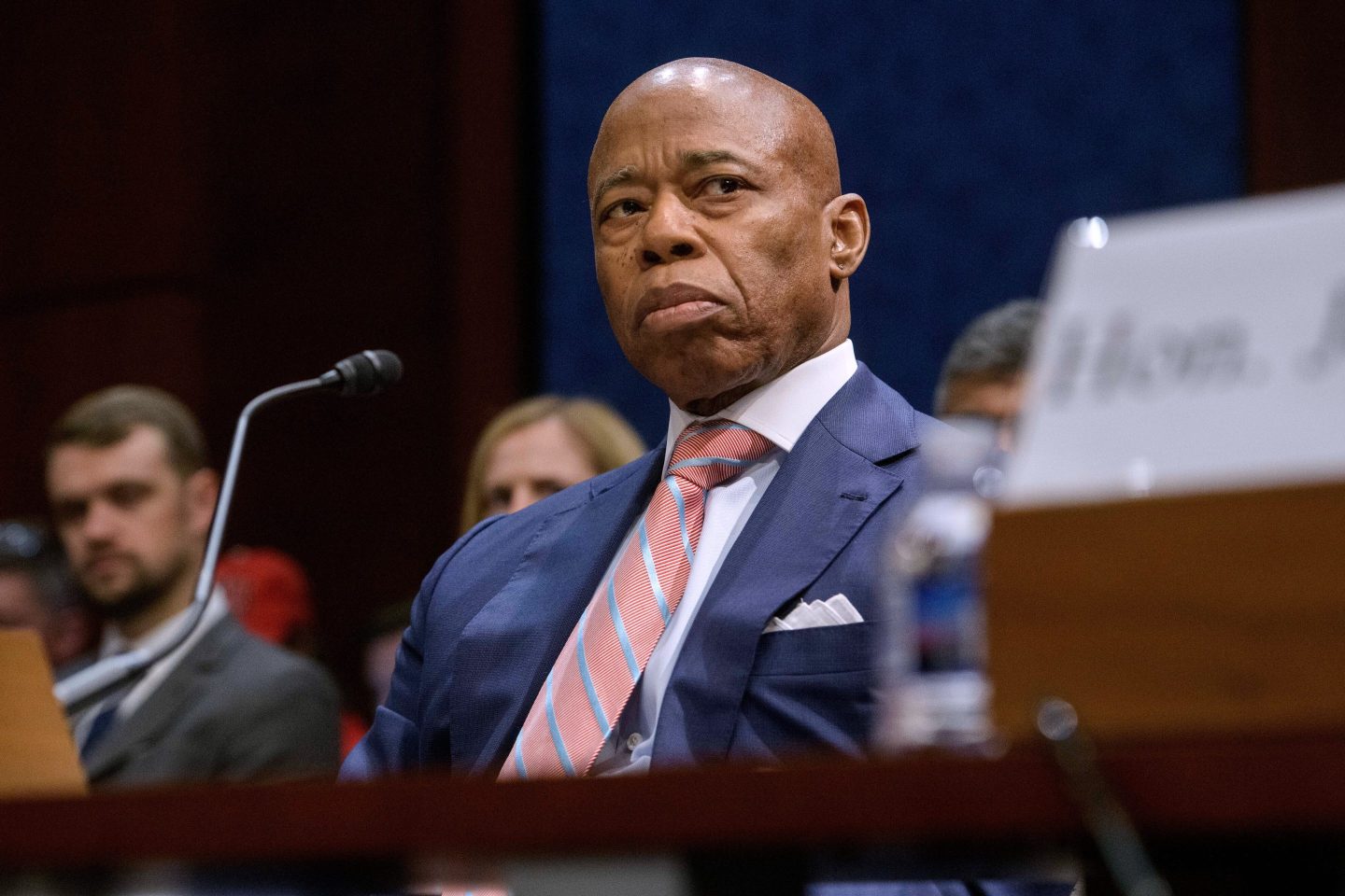 Eric Adams sits in a courtroom