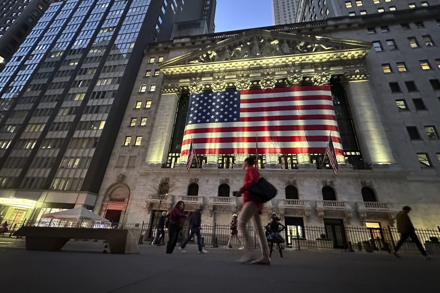 People walk in front of the New York Stock Exchange