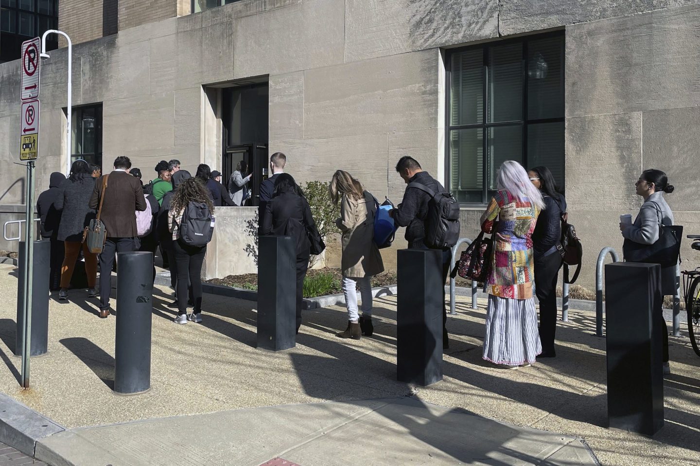 Workers stand outside the Health and Human Services building