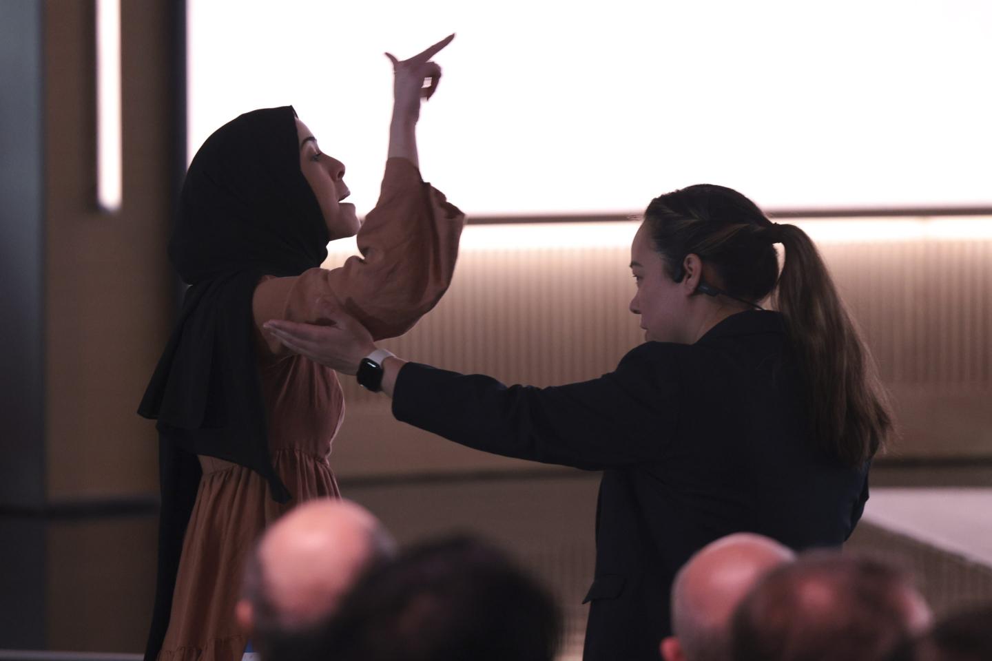 A pro-Palestinian demonstrator, Ibtihal Aboussad, is escorted away by security ahead of a 50th anniversary presentation at Microsoft headquarters in Redmond, Wash., on Friday.