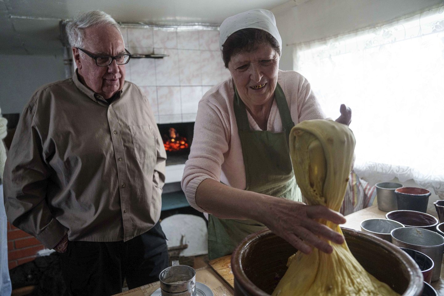 Howard G. Buffett, chief executive officer of the Howard G. Buffett Foundation together with Ukraine's Minister of Economy Yuliia Svyrydenko and local woman cook easter bread at their house in Popivka, Sumy region, Ukraine, April 5, 2025.