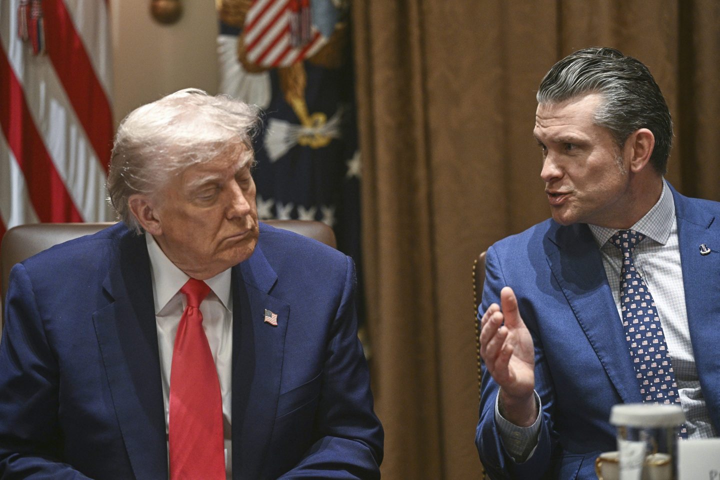 President Donald Trump listens as Defense Secretary Pete Hegseth speaks at a cabinet meeting in the Cabinet Room of the White House, on April 10, 2025, in Washington.