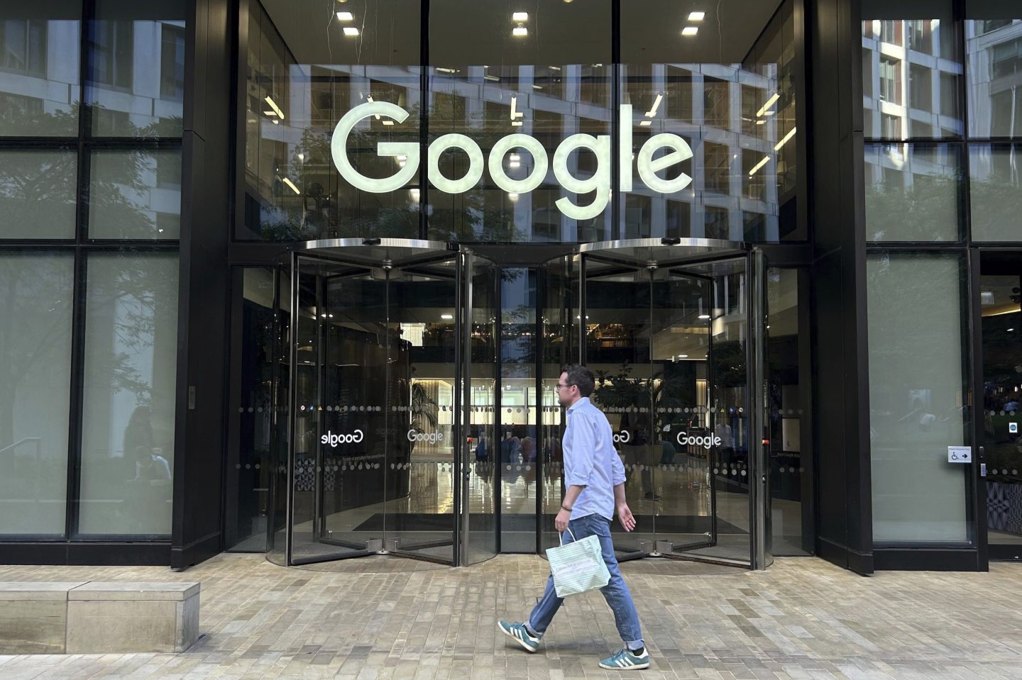 A man walks in front of Google's London HQ