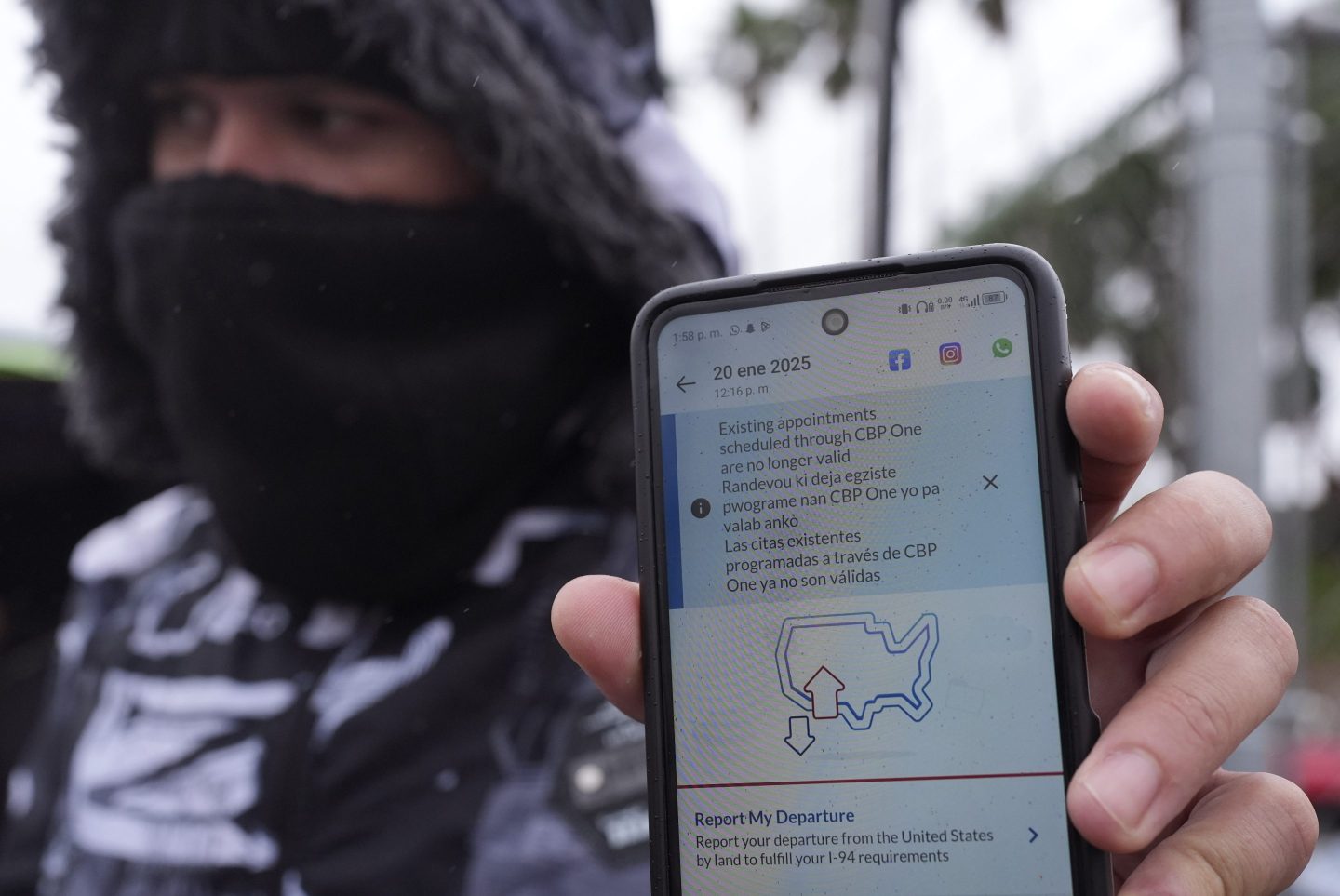 A migrant seeking asylum holds up the CBP One app showing his appointment was canceled after President Donald Trump was sworn into office, Jan. 20, 2025, in Matamoros, Mexico.