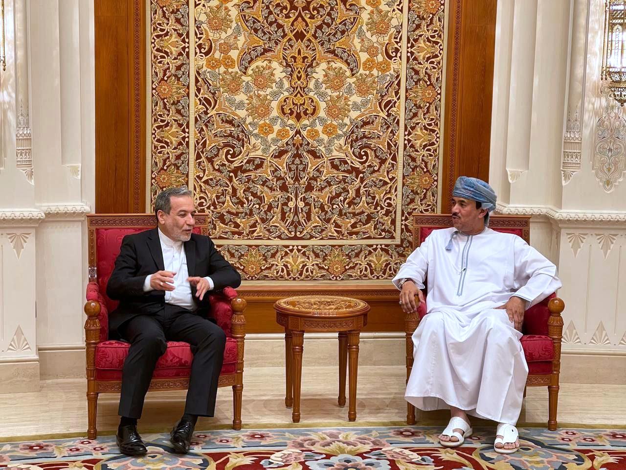 Two men sit in chairs to talk about Iran's nuclear program