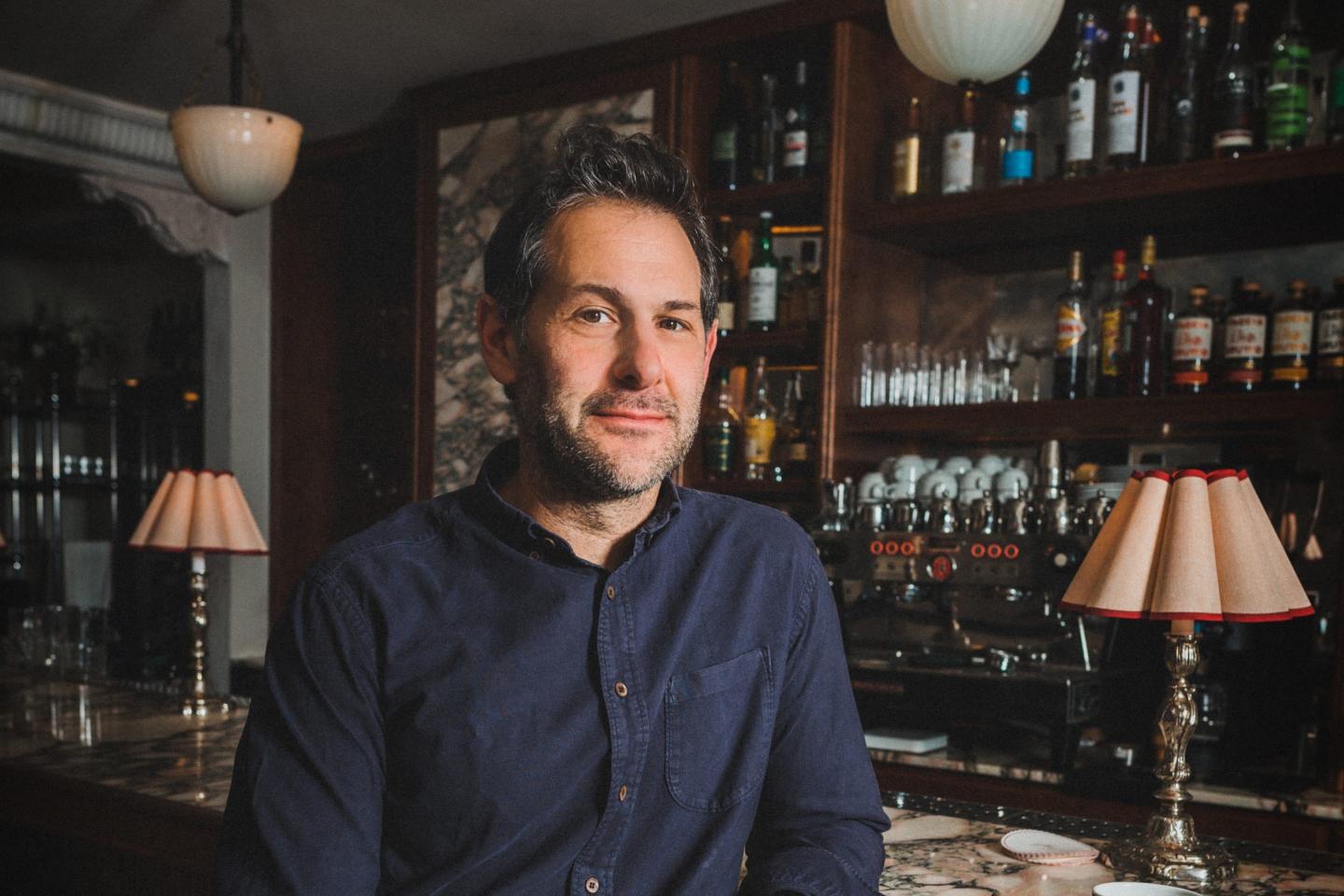 Ben Leventhal sits for a portrait inside a restaurant.