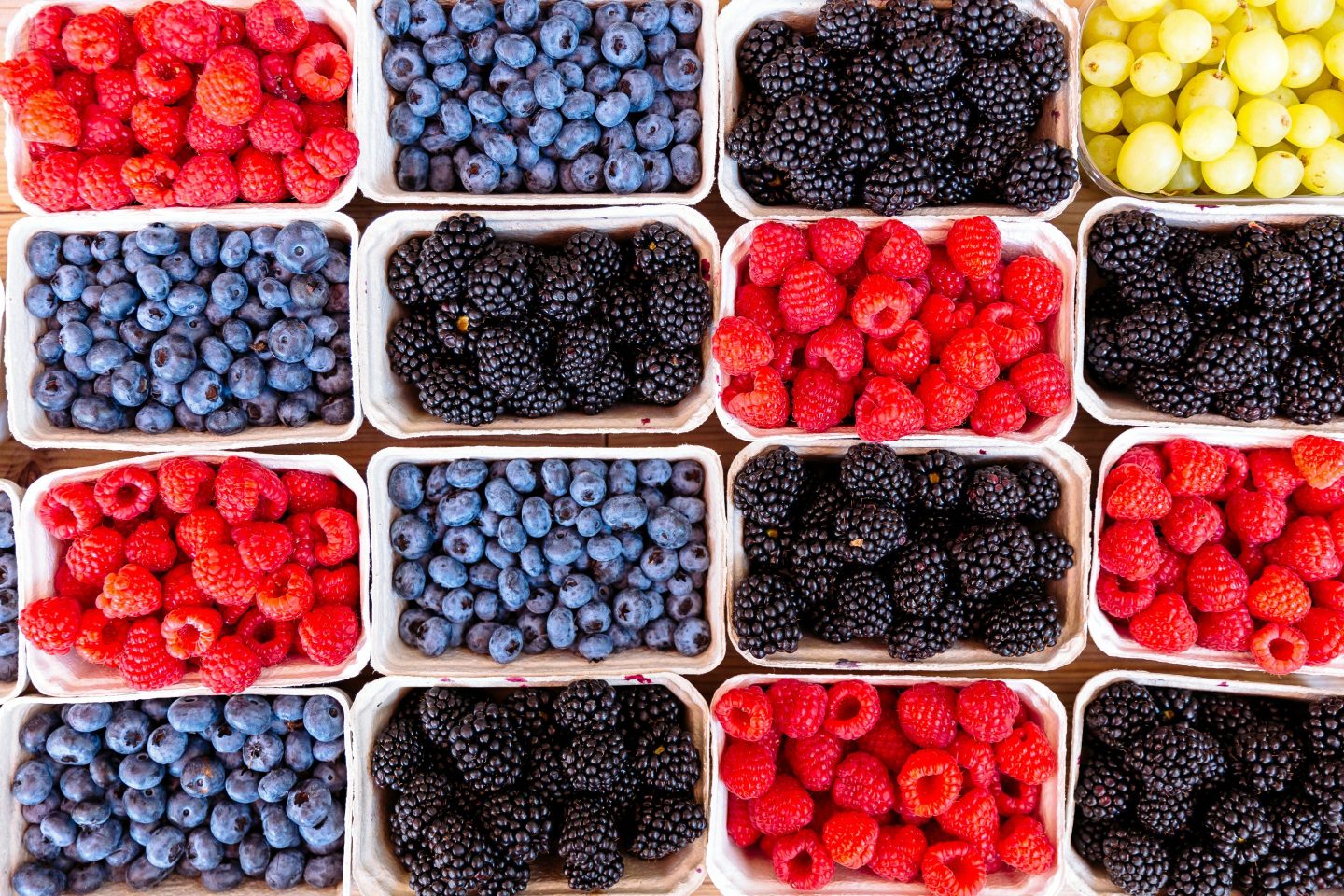 closeup of various berries in open rectangular containers