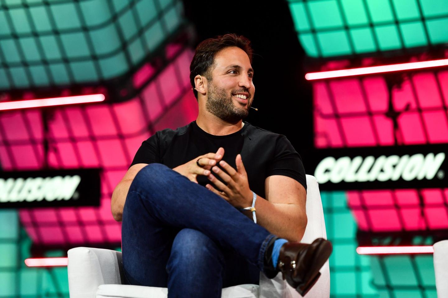 Kyle Samani speaks on stage in 2022 at a conference.