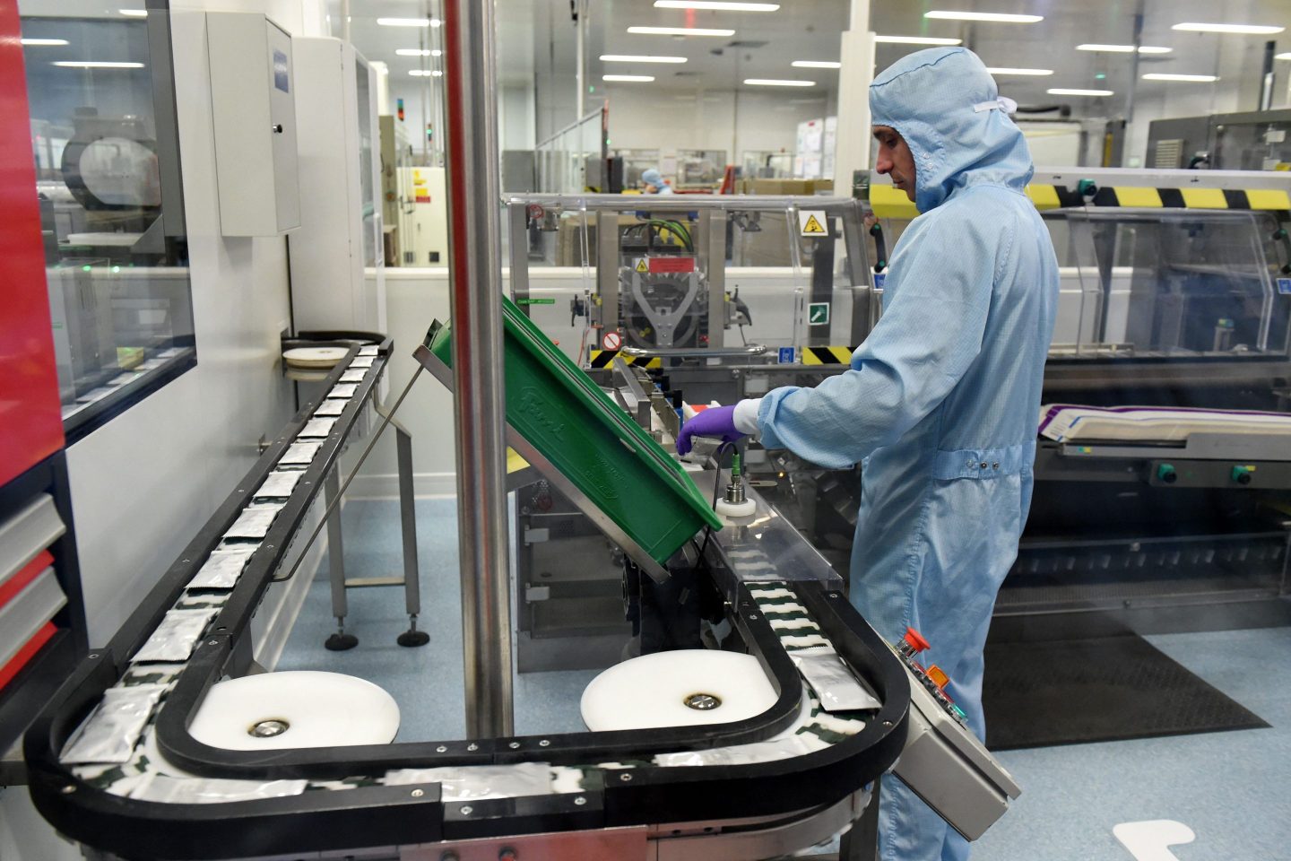 An employee poses controls Augmentin tablets on a production line at the GSK pharmaceutical laboratory in Mayenne, western France, on Jan. 5, 2023.