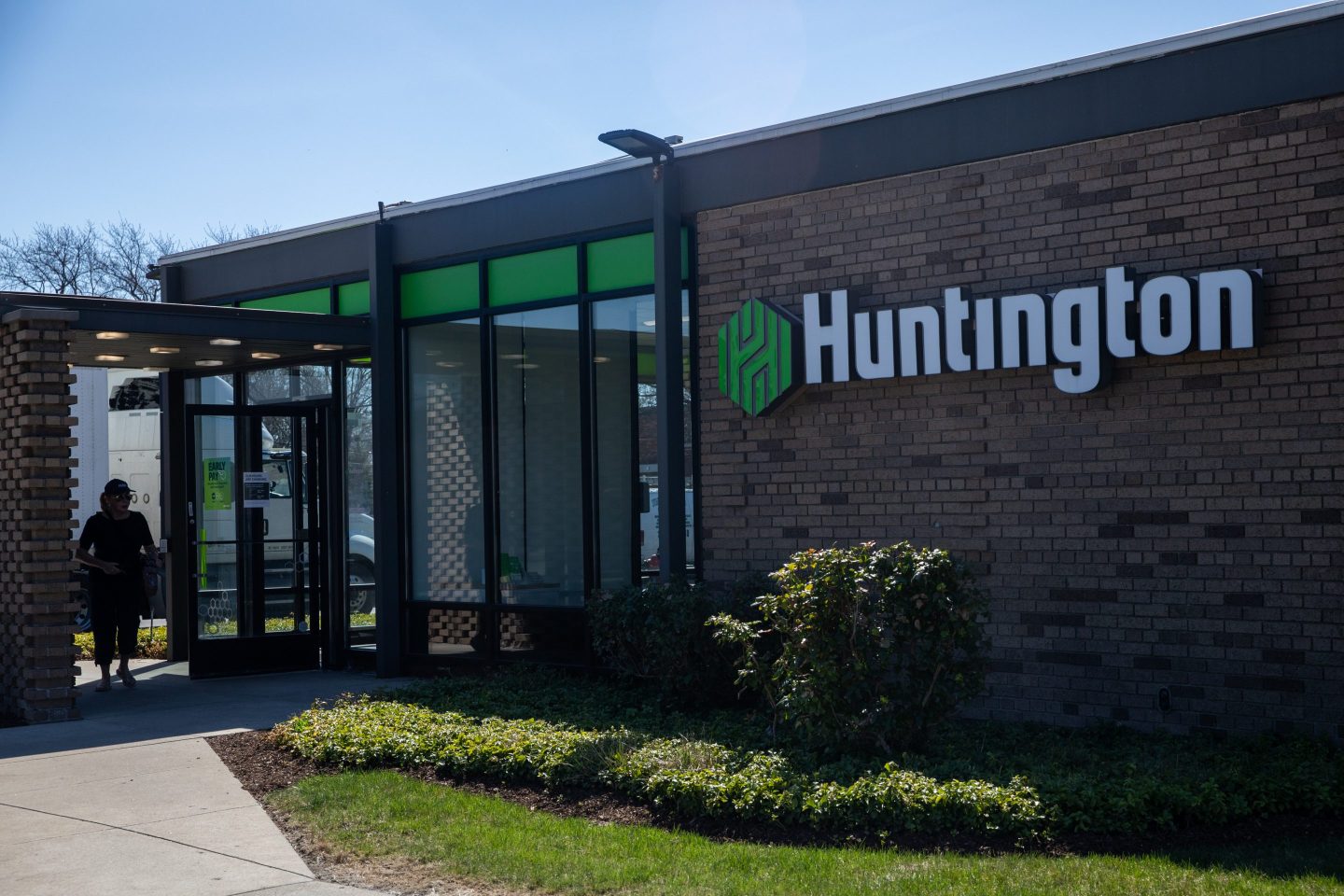 the exterior of a bank building with a "Huntington" sign