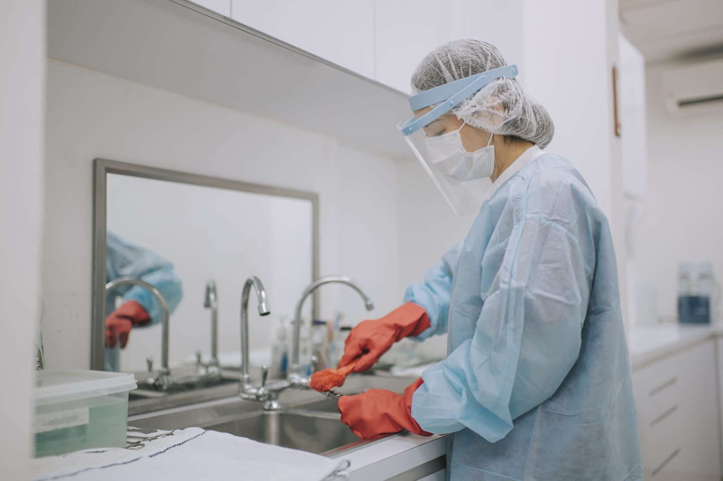 Worker cleaning medical equipment.