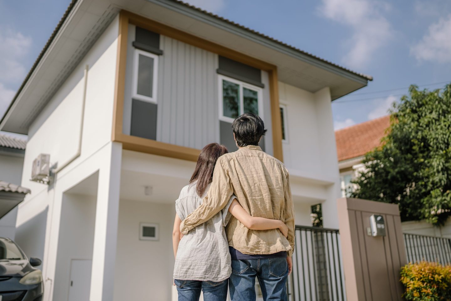 A couple standing outside a new house