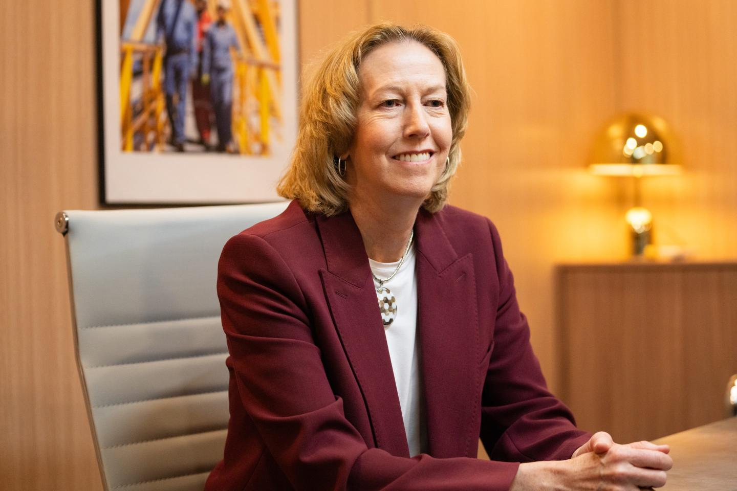 Woodside Energy CEO Meg O'Neill speaks while seated on the sidelines of an energy conference.