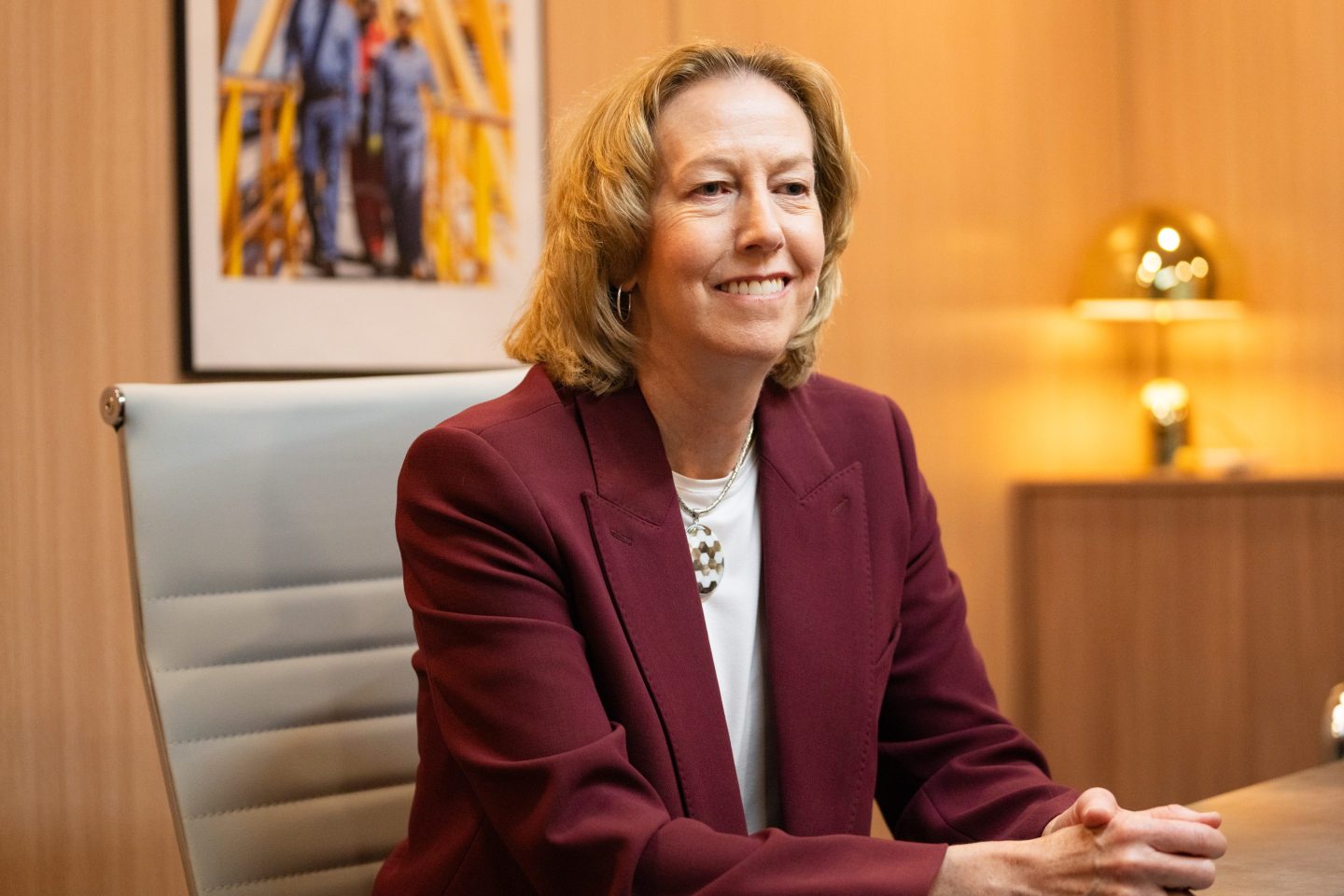 Woodside Energy CEO Meg O'Neill speaks while seated on the sidelines of an energy conference.