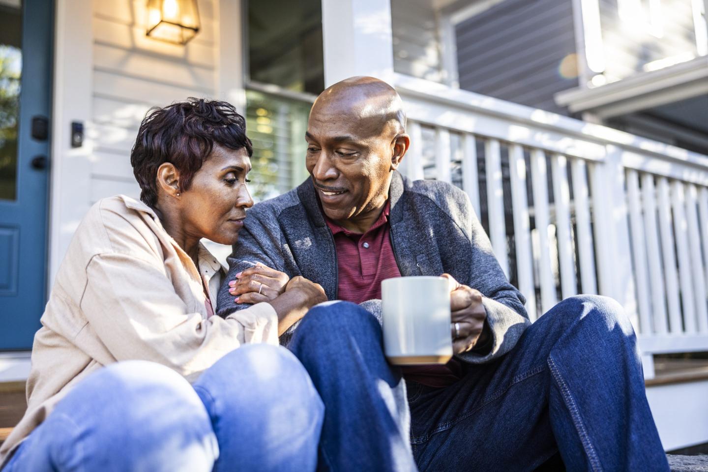 Senior couple having coffee together on their porch