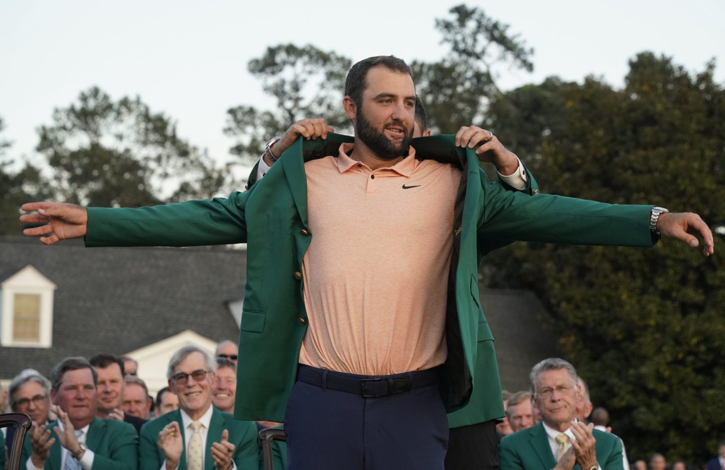 Scottie Scheffler of the United States puts on the green jacket during the awarding ceremony for the 2024 Masters golf tournament at Augusta National Golf Club in Augusta, Georgia, the United States on April 14, 2024.