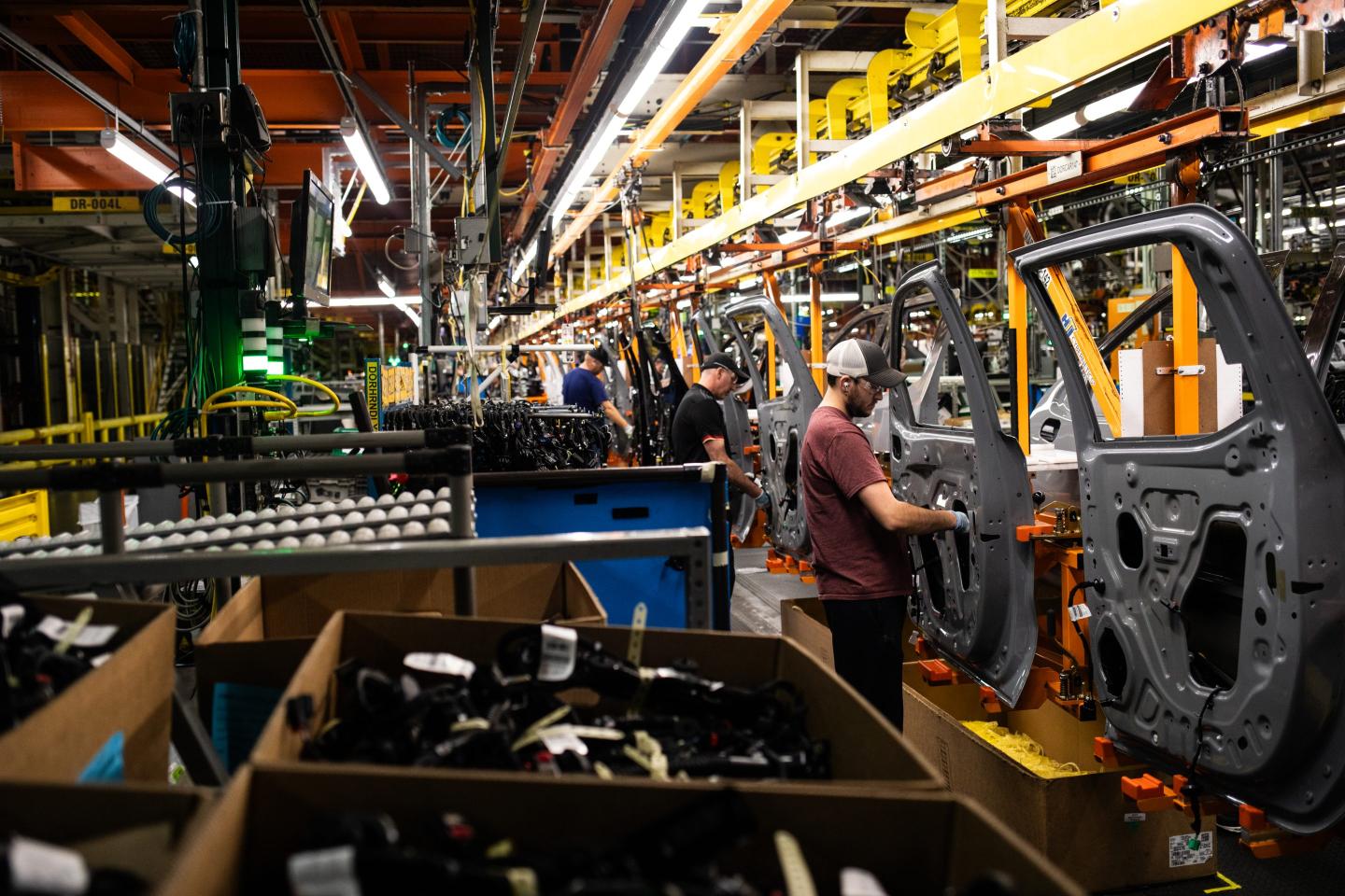 Workers assemble vehicle doors at the General Motors assembly plant in Fort Wayne, Ind., in 2024. 