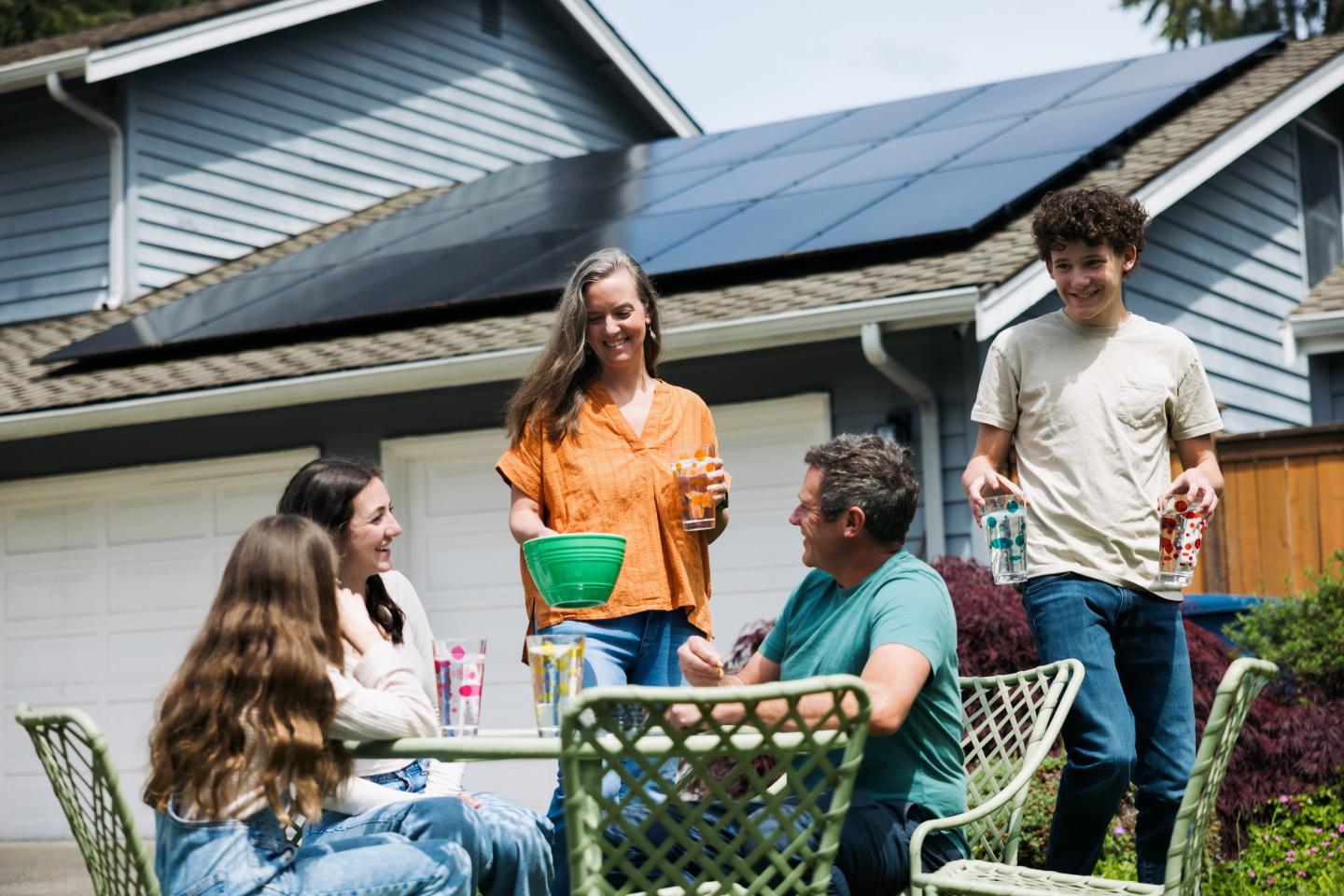 people with solar panel in background