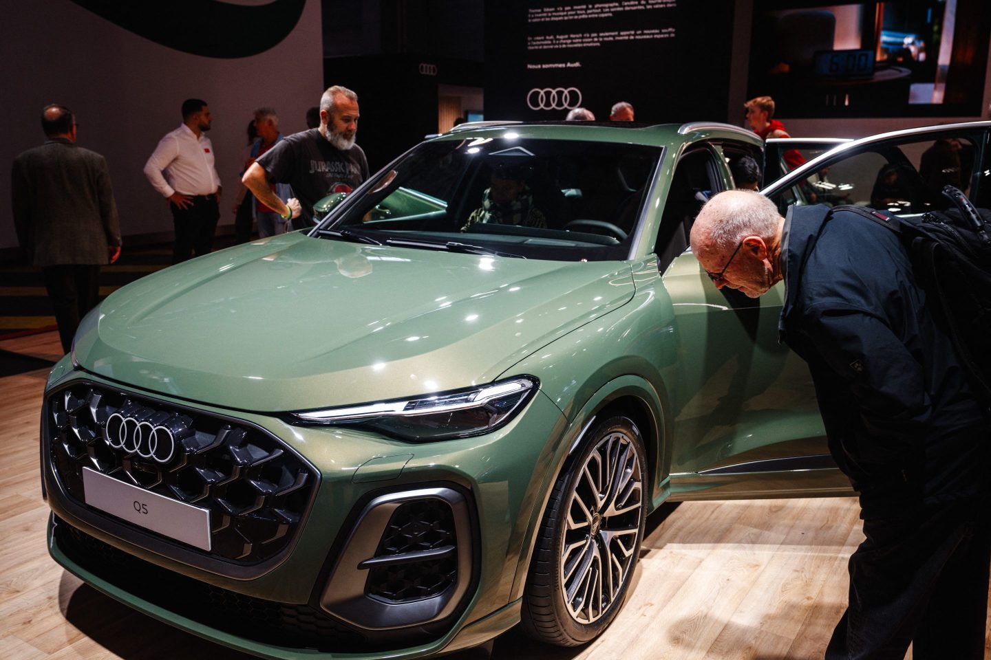 guests looking at Audi Q5 model