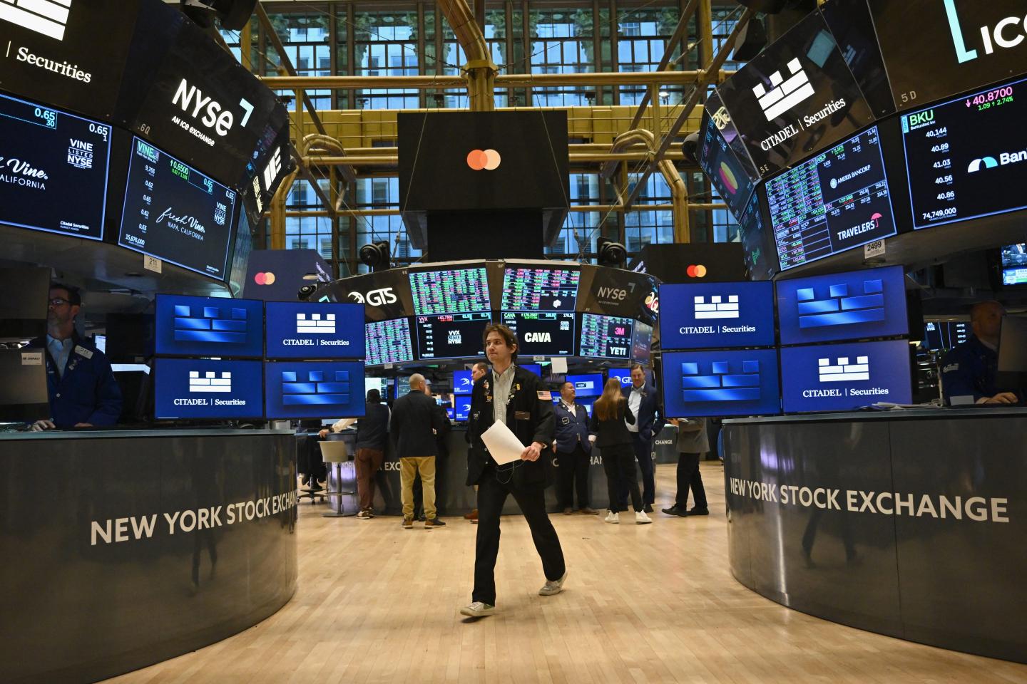 Wall Street worker walking through trading floor