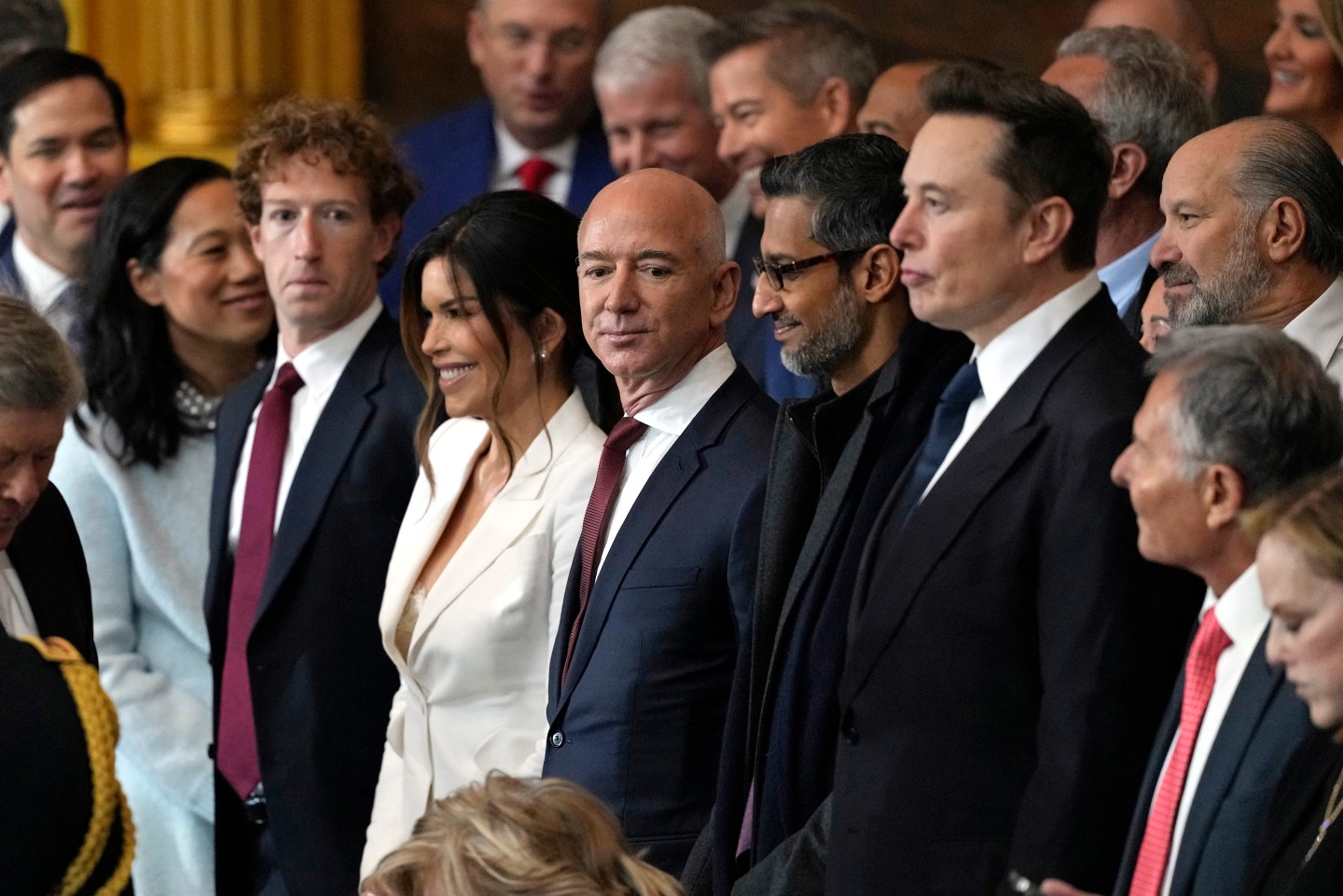 Mark Zuckerberg, Lauren Sanchez, Jeff Bezos, Sundar Pichai and Elon Musk standing together at Trump's inauguration