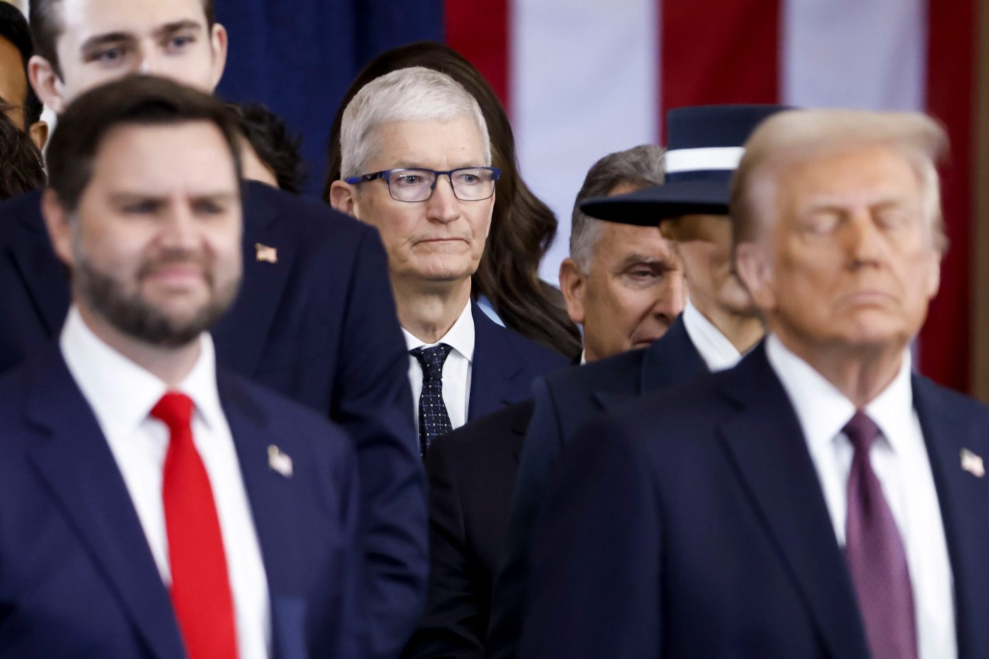 Tim Cook stands behind Vance and Trump.