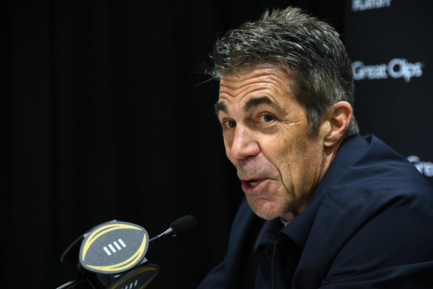 Chris Fowler speaks into a microphone