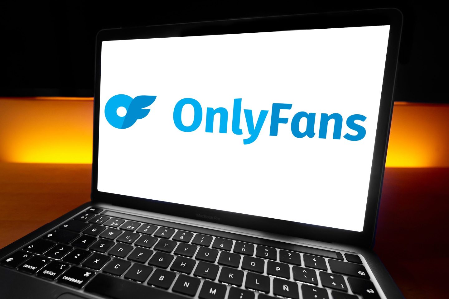 The OnlyFans logo on a MacBook