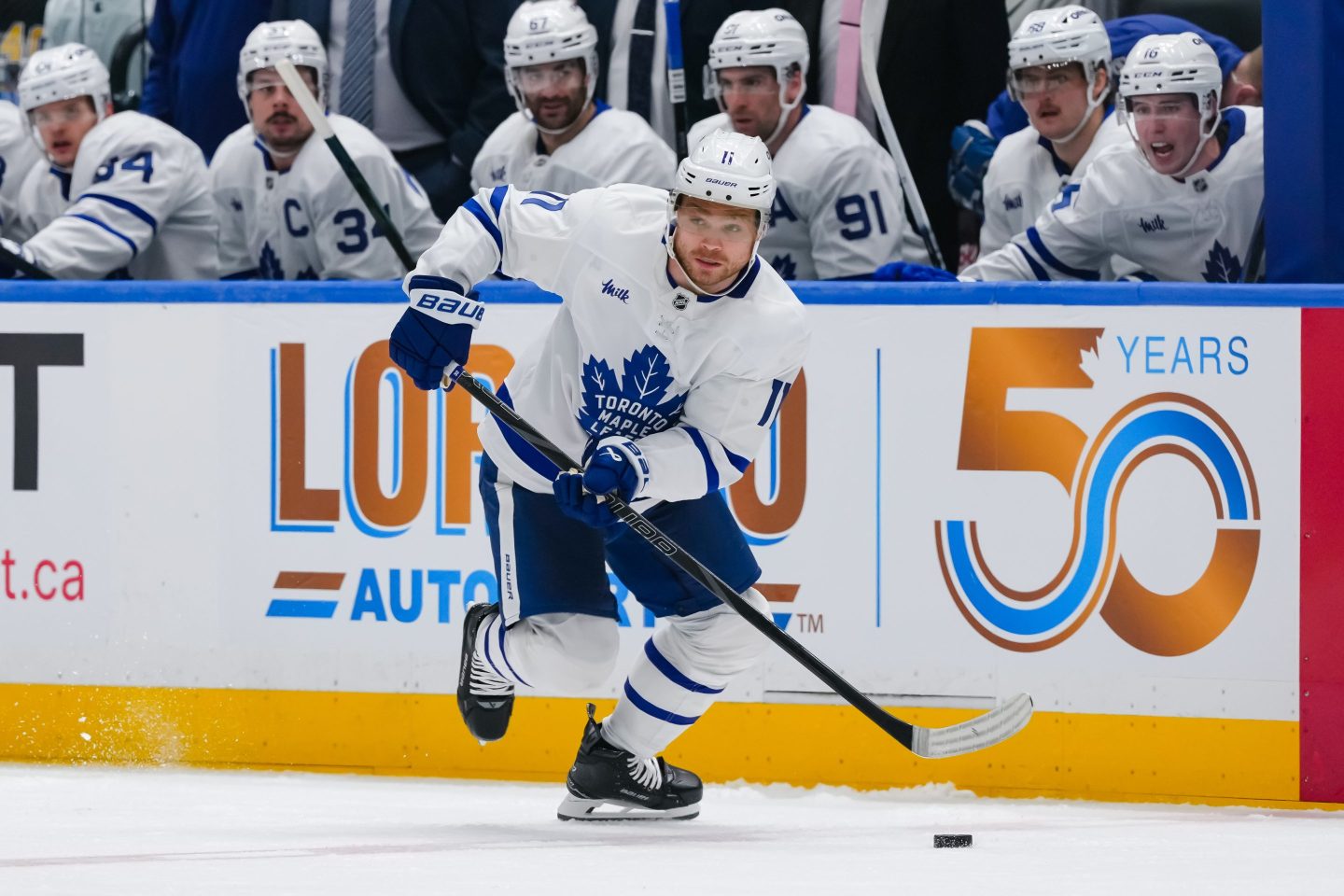 A Toronto Maple Leafs player skates in front of his team