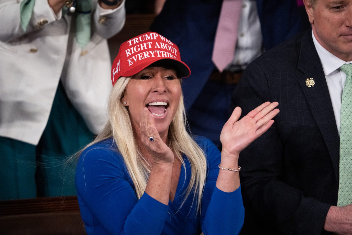 Marjorie Taylor Greene wears a hat reading "Trump was right about everything"