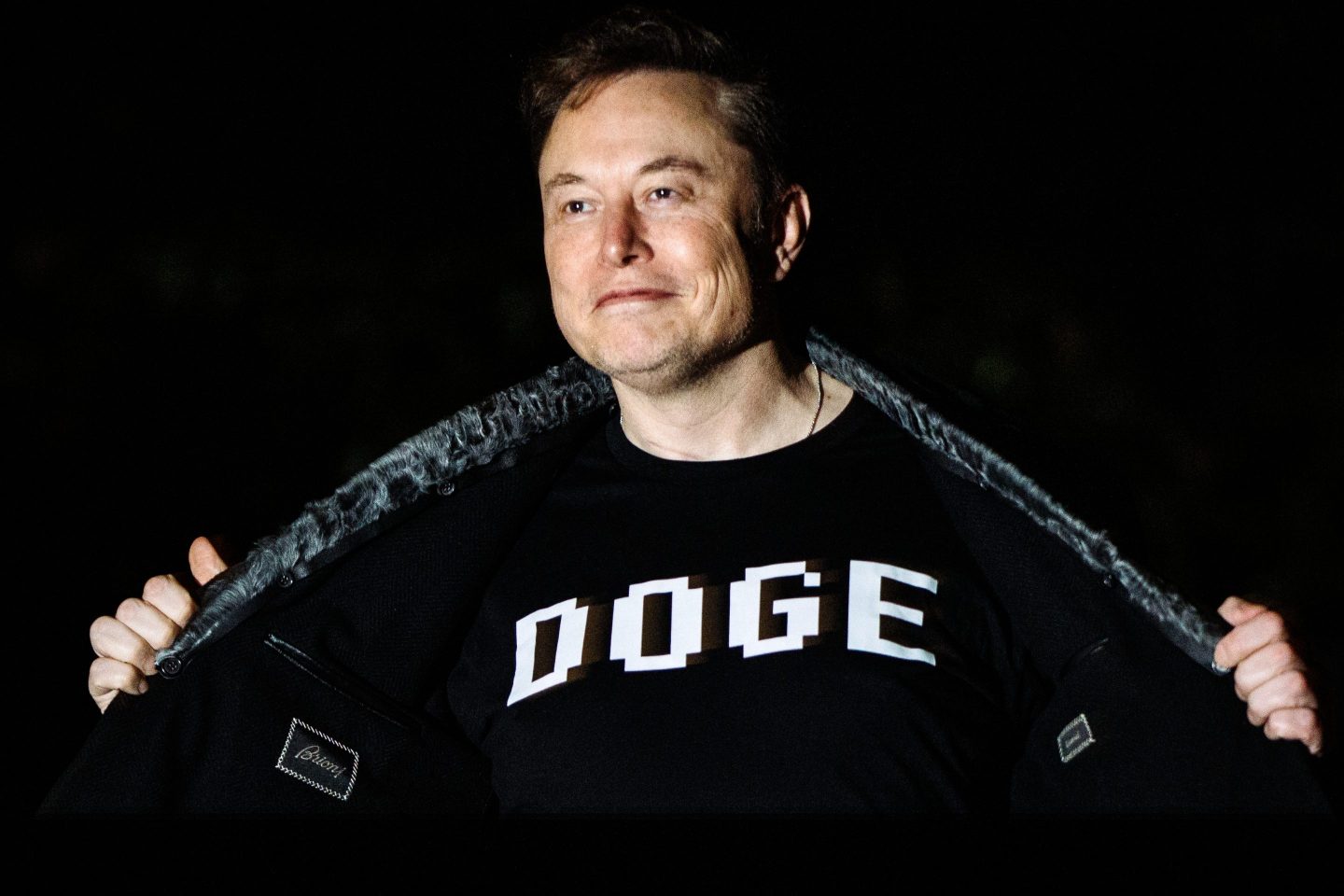 Elon Musk wearing a DOGE t-shirt.