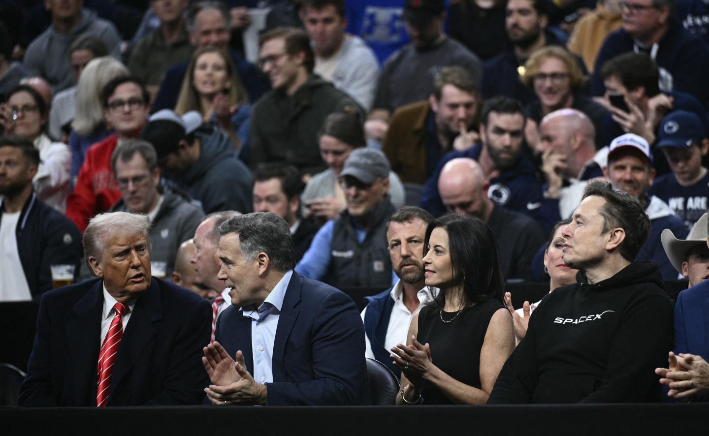 US President Donald Trump, Senator Dave McCormick, his wife Dina Powell McCormick and Elon Musk watch the men's NCAA wrestling competition at the Wells Fargo Center in Philadelphia, Pennsylvania, on March 22, 2025.