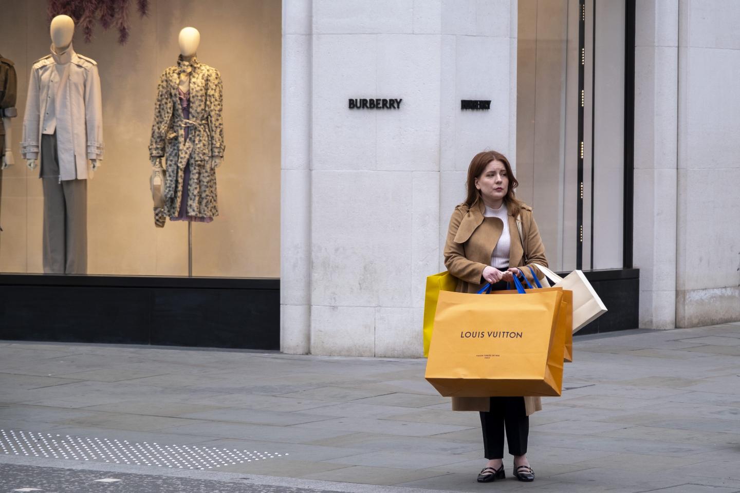 woman standing in the street with shopping bags