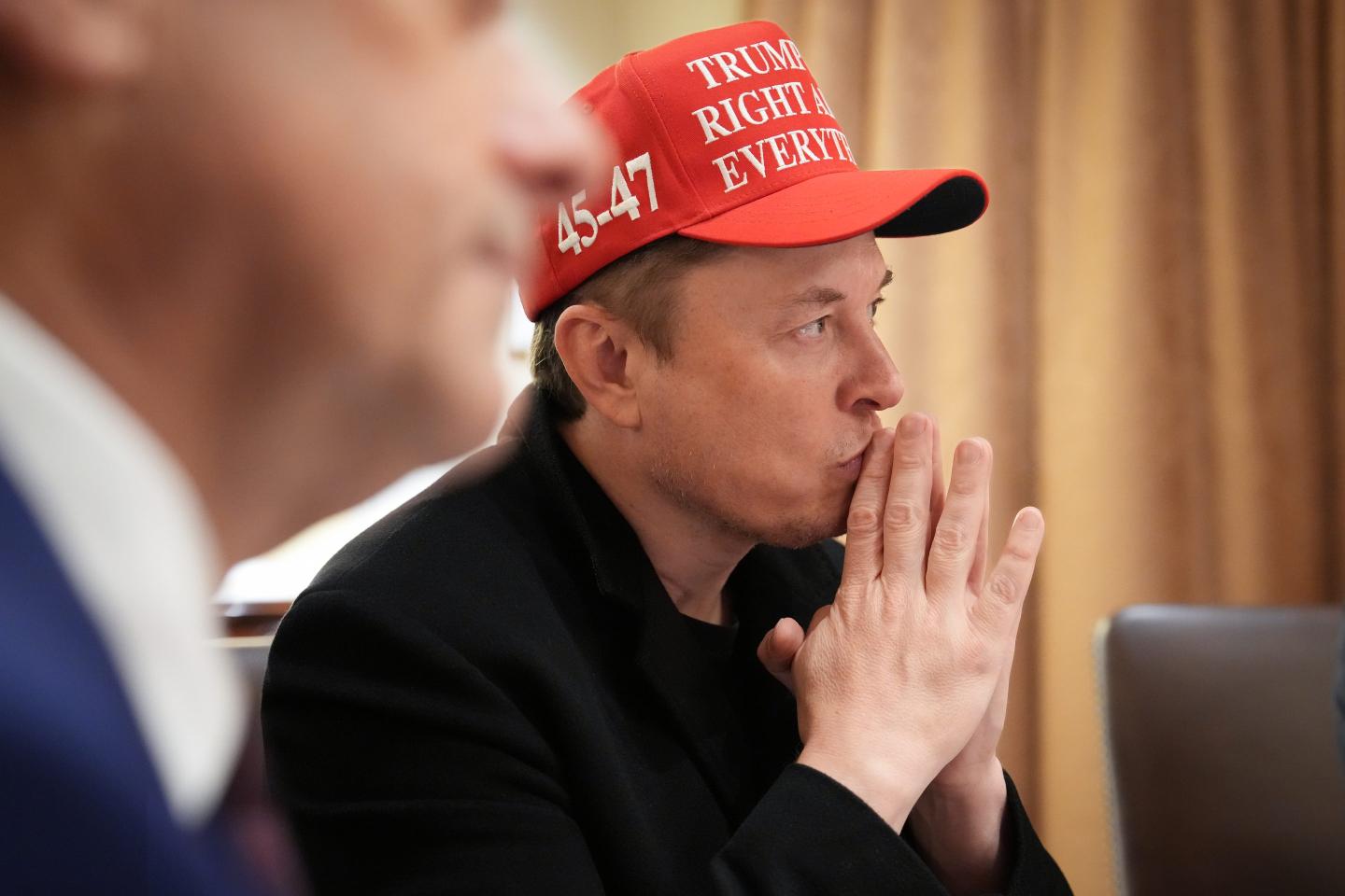 Elon Musk making a finger tent