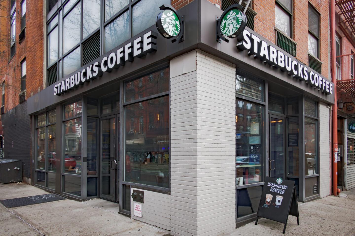 exterior shot of a Starbucks coffee on a street corner