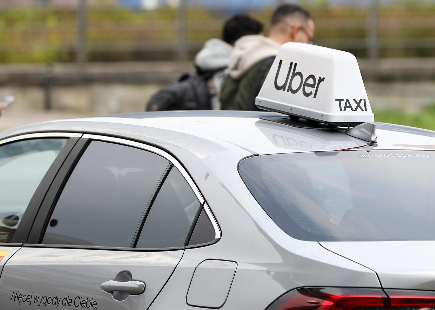 A car with an Uber sign on top.