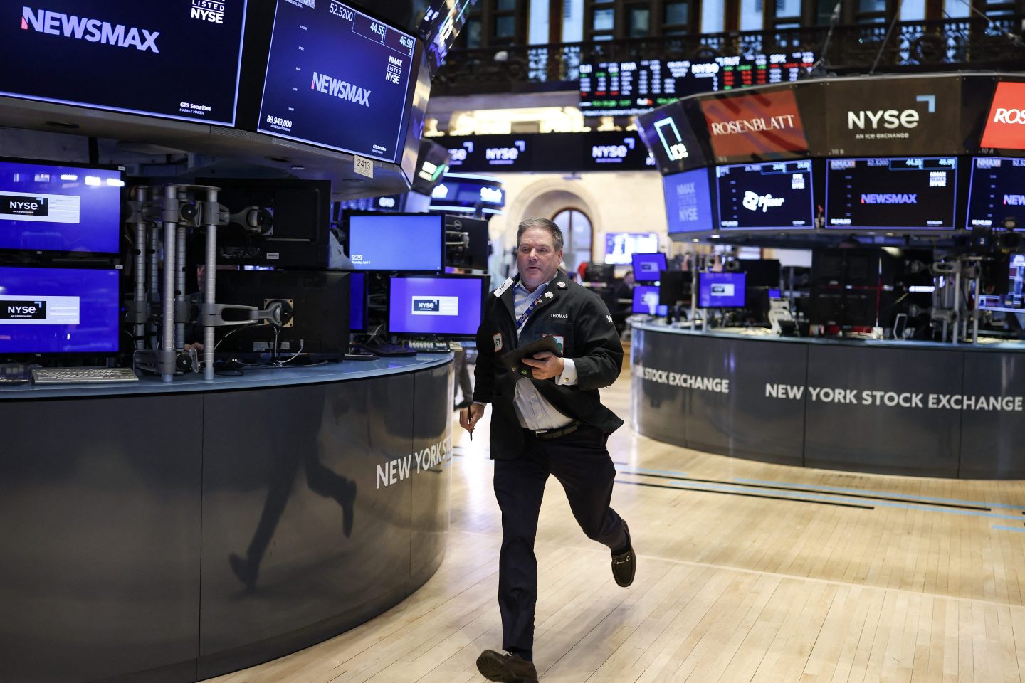 A trader runs on the floor of the New York Stock Exchange at the opening bell