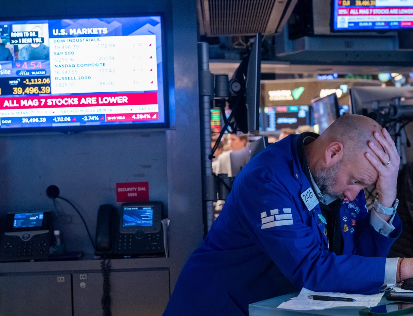 A stock trader with his head in his hands