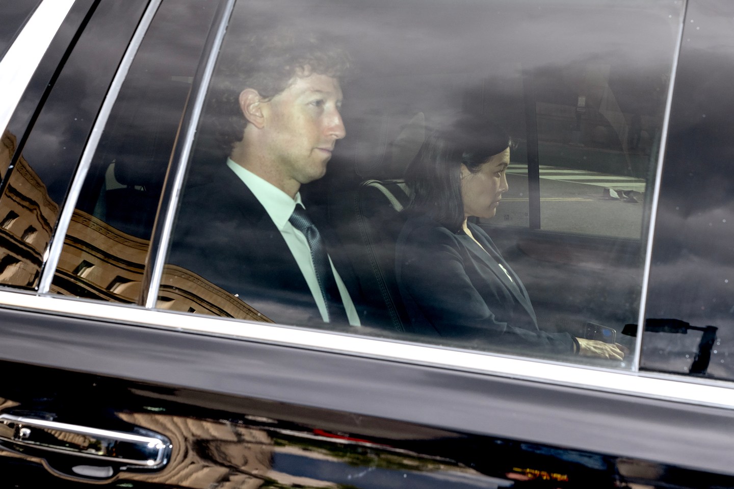 Mark Zuckerberg is photographed through a car window.