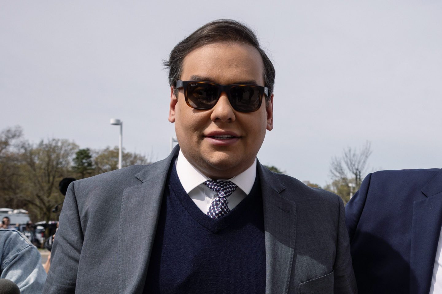 George Santos wears a pair of sunglasses outside the courthouse